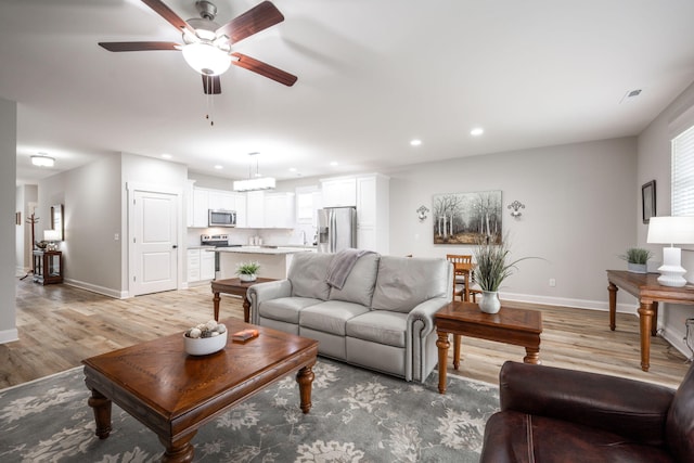 8647 Kensley Ln, Hixson, TN 37343 - living room featuring baseboards, a ceiling fan, light wood finished floors, and recessed lighting