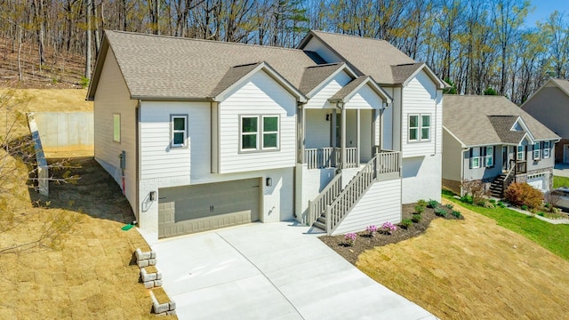 1384 Unity Dr NE, Cleveland, TN 37312 - view of front facade with stairway, concrete driveway, covered porch, and an attached garage