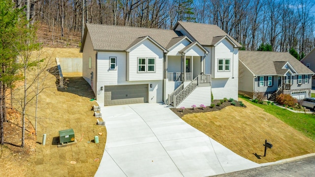 1384 Unity Dr NE, Cleveland, TN 37312 - view of front of house featuring driveway, stairway, a garage, a porch, and roof with shingles