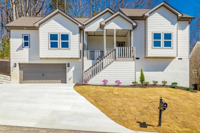 1384 Unity Dr NE, Cleveland, TN 37312 - view of front of house featuring brick siding, an attached garage, concrete driveway, a porch, and stairs