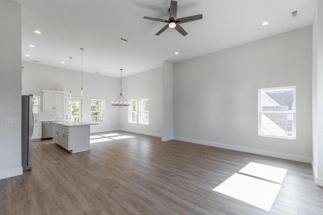 1384 Unity Dr NE, Cleveland, TN 37312 - unfurnished living room featuring recessed lighting, a ceiling fan, baseboards, wood finished floors, and a chandelier