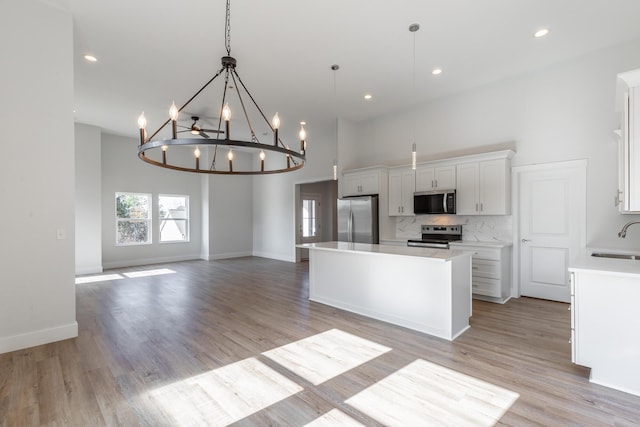 1384 Unity Dr NE, Cleveland, TN 37312 - kitchen with appliances with stainless steel finishes, a sink, a center island, white cabinets, and light countertops