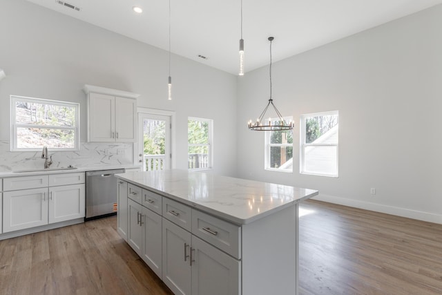 1384 Unity Dr NE, Cleveland, TN 37312 - kitchen with dishwasher, a sink, light wood finished floors, a chandelier, and a towering ceiling
