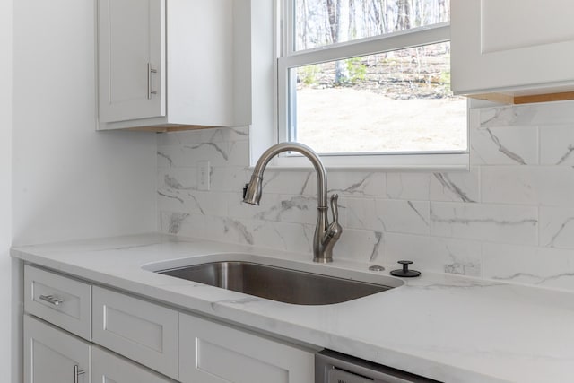1384 Unity Dr NE, Cleveland, TN 37312 - kitchen featuring a sink, tasteful backsplash, white cabinets, and light stone counters