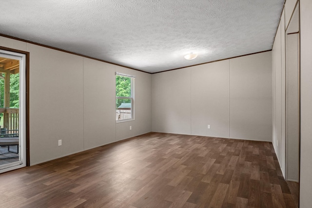 934 Holly Glen Ln, Decatur, TN 37322 - spare room featuring ornamental molding, wood finished floors, a textured ceiling, and a decorative wall