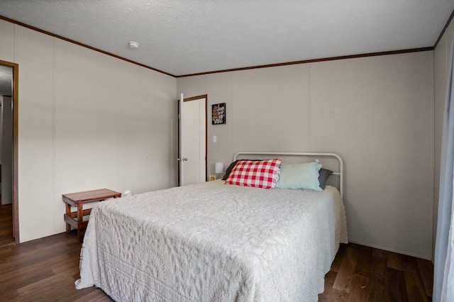 934 Holly Glen Ln, Decatur, TN 37322 - bedroom featuring crown molding, dark wood finished floors, a decorative wall, and a textured ceiling