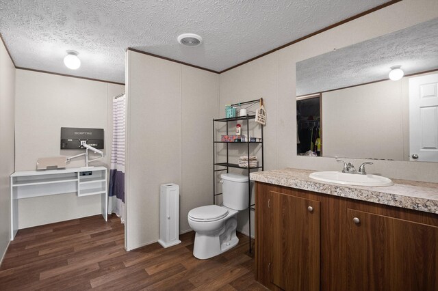 934 Holly Glen Ln, Decatur, TN 37322 - full bath with wood finished floors, vanity, a textured ceiling, toilet, and crown molding