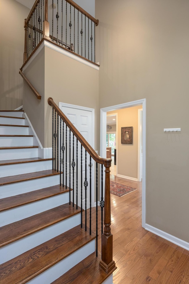 6063 Heritage Ridge Dr, Hixson, TN 37343 - stairway with wood finished floors, baseboards, and a towering ceiling