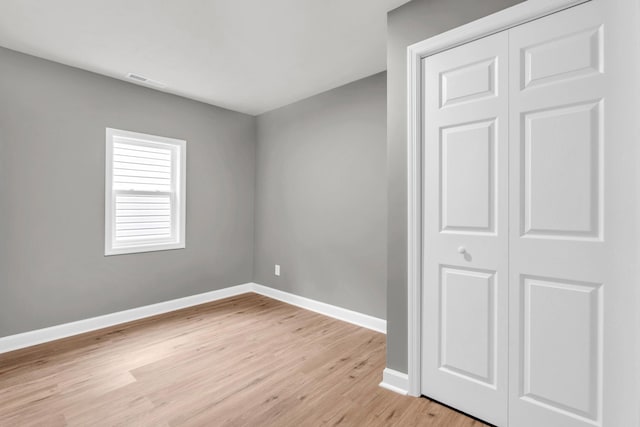 1904 Sharp St, Chattanooga, TN 37404 - unfurnished bedroom with light wood finished floors, baseboards, and a closet