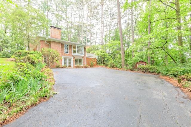 302 Brookwood Ln, Lafayette, GA 30728 - view of front facade featuring a chimney, french doors, brick siding, and asphalt driveway