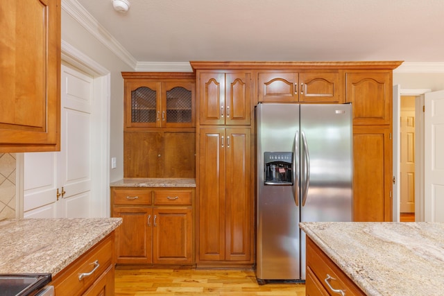 302 Brookwood Ln, Lafayette, GA 30728 - kitchen featuring stainless steel fridge with ice dispenser, brown cabinets, light stone countertops, ornamental molding, and light wood finished floors