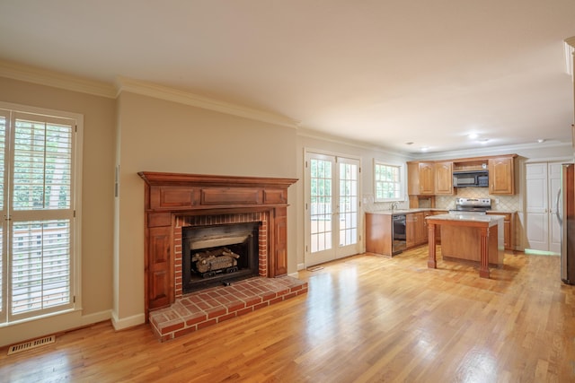 302 Brookwood Ln, Lafayette, GA 30728 - living area featuring crown molding, light wood-style flooring, a fireplace, plenty of natural light, and baseboards