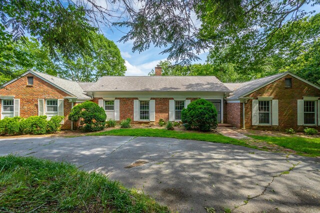 1613 Fairy Dell Trl, Lookout Mountain, GA 30750 - view of front of house with brick siding and a chimney