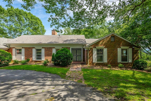 1613 Fairy Dell Trl, Lookout Mountain, GA 30750 - single story home with brick siding, a chimney, a front lawn, and a shingled roof