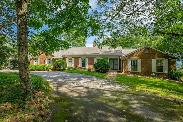 1613 Fairy Dell Trl, Lookout Mountain, GA 30750 - single story home featuring asphalt driveway, brick siding, a front lawn, and a chimney