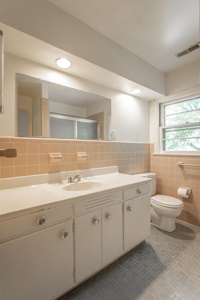 1613 Fairy Dell Trl, Lookout Mountain, GA 30750 - bathroom featuring tile walls, vanity, toilet, a stall shower, and tile patterned floors