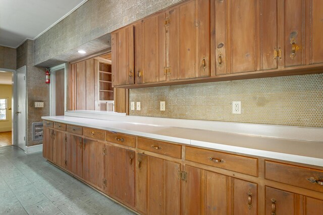 1613 Fairy Dell Trl, Lookout Mountain, GA 30750 - kitchen featuring brown cabinets, light countertops, backsplash, and light flooring
