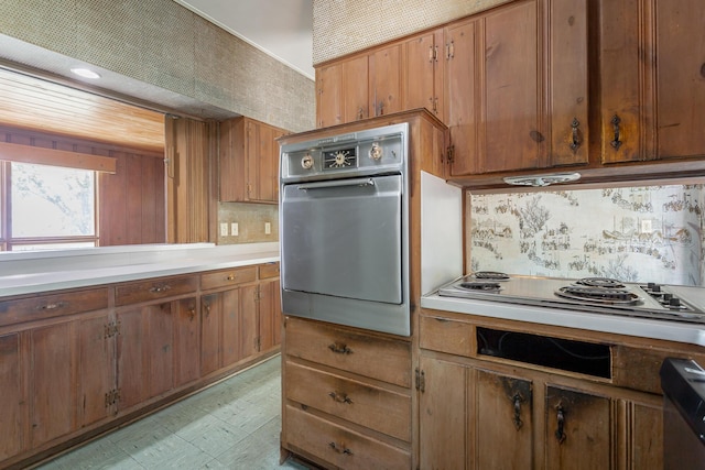1613 Fairy Dell Trl, Lookout Mountain, GA 30750 - kitchen with appliances with stainless steel finishes, brown cabinetry, backsplash, and light countertops