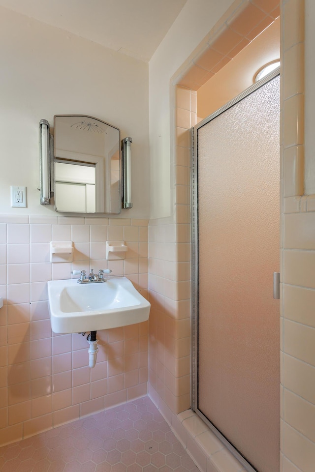 1613 Fairy Dell Trl, Lookout Mountain, GA 30750 - bathroom featuring a shower stall, tile walls, a sink, and wainscoting