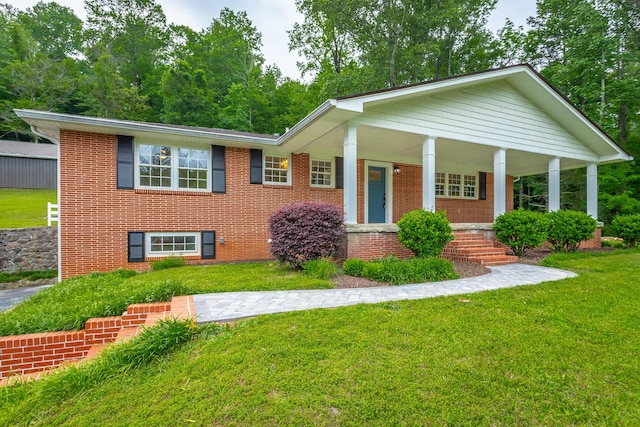 5873 Old Dayton Pike, Chattanooga, TN 37415 - view of front of property with a front lawn, brick siding, and covered porch