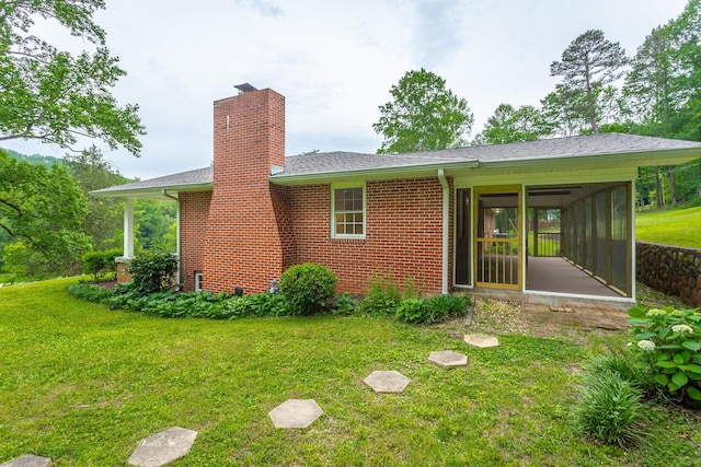 5873 Old Dayton Pike, Chattanooga, TN 37415 - back of house with a sunroom, a chimney, brick siding, and a lawn