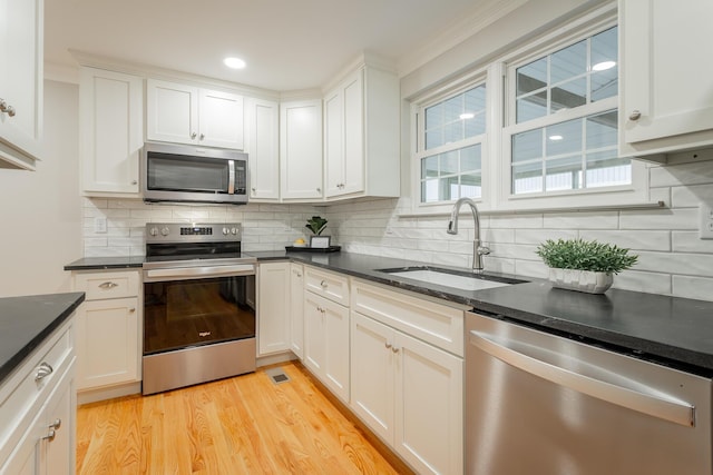 5873 Old Dayton Pike, Chattanooga, TN 37415 - kitchen featuring stainless steel appliances, a sink, tasteful backsplash, light wood-style floors, and crown molding