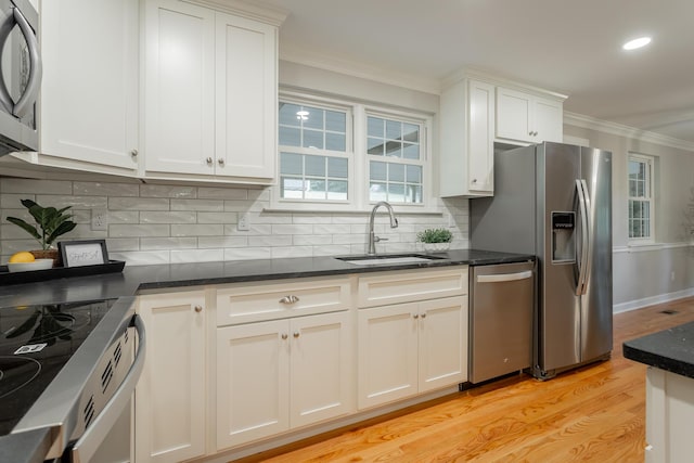 5873 Old Dayton Pike, Chattanooga, TN 37415 - kitchen featuring a sink, stainless steel appliances, crown molding, light wood-style floors, and backsplash