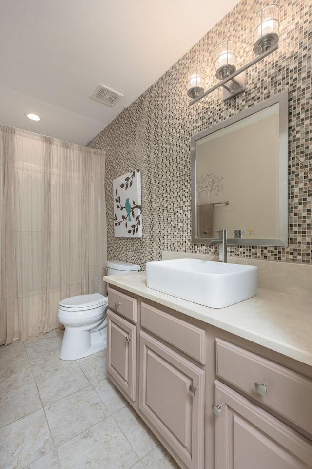 6245 Heritage Ridge Dr, Hixson, TN 37343 - bathroom featuring toilet, vanity, tile walls, and tasteful backsplash