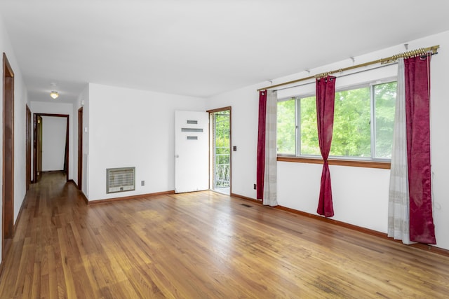 7750 Vista Hills Dr, Chattanooga, TN 37416 - empty room with heating unit, wood finished floors, and baseboards