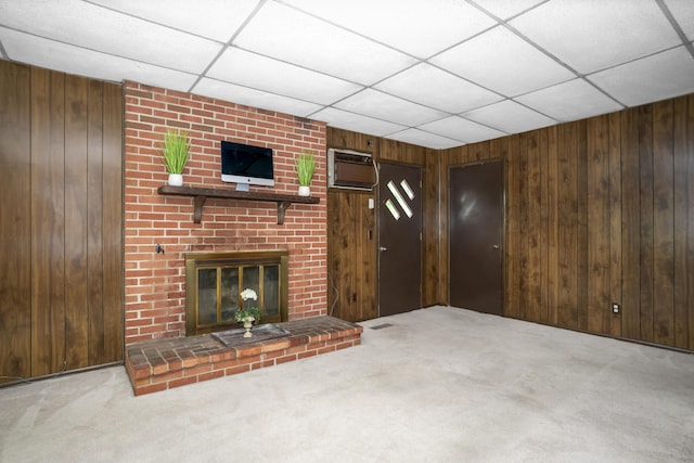 7750 Vista Hills Dr, Chattanooga, TN 37416 - unfurnished living room with wood walls, carpet, a wall unit AC, a fireplace, and a paneled ceiling