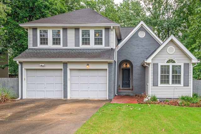 2418 Charleston Sq, Chattanooga, TN 37421 - view of front facade with driveway, an attached garage, a front yard, roof with shingles, and brick siding
