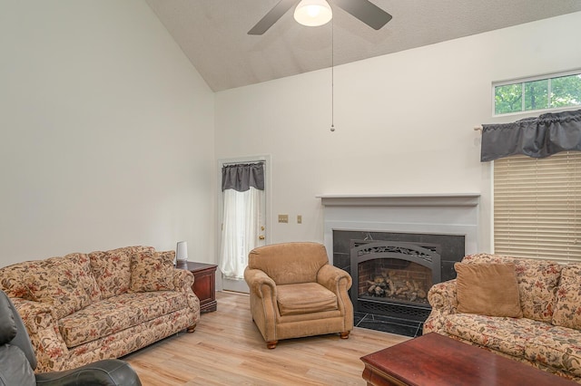 2418 Charleston Sq, Chattanooga, TN 37421 - living room featuring a fireplace, ceiling fan, light wood-style floors, and high vaulted ceiling