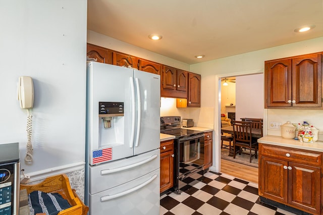 2418 Charleston Sq, Chattanooga, TN 37421 - kitchen featuring white refrigerator with ice dispenser, black electric range, dark flooring, light countertops, and recessed lighting