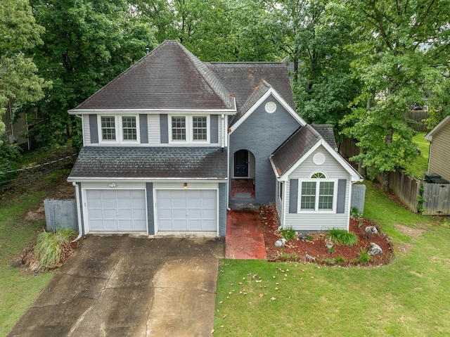 2418 Charleston Sq, Chattanooga, TN 37421 - view of front of property with driveway, roof with shingles, a garage, brick siding, and view of scattered trees