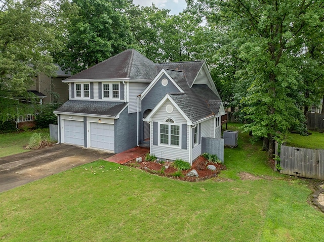 2418 Charleston Sq, Chattanooga, TN 37421 - traditional-style house featuring driveway, an attached garage, central air condition unit, roof with shingles, and view of wooded area