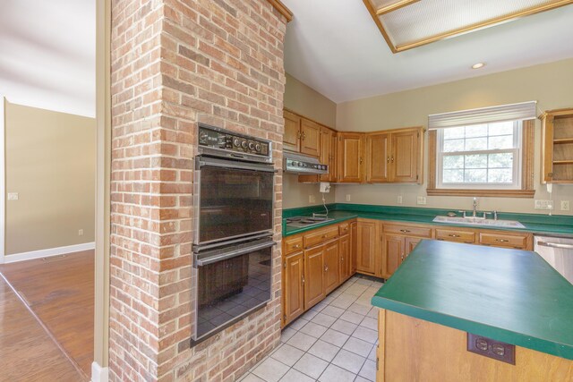 7902 Ooltewah Georgetown Rd, Ooltewah, TN 37363 - kitchen featuring multiple ovens, a sink, under cabinet range hood, cooktop, and light tile patterned floors