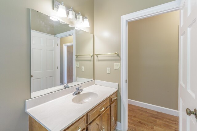 7902 Ooltewah Georgetown Rd, Ooltewah, TN 37363 - bathroom with vanity, wood finished floors, and baseboards