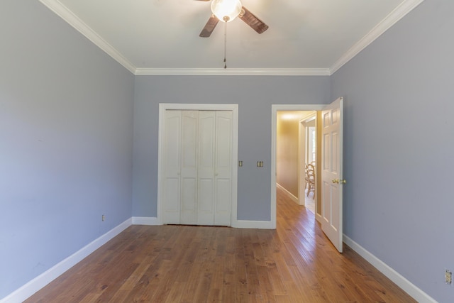7902 Ooltewah Georgetown Rd, Ooltewah, TN 37363 - unfurnished bedroom featuring crown molding, a closet, wood finished floors, and baseboards