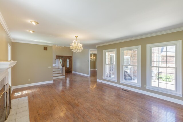 7902 Ooltewah Georgetown Rd, Ooltewah, TN 37363 - unfurnished living room featuring a chandelier, baseboards, crown molding, light wood-type flooring, and a fireplace