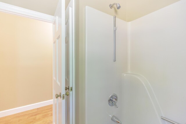 7902 Ooltewah Georgetown Rd, Ooltewah, TN 37363 - bathroom with tub / shower combination, wood finished floors, and baseboards