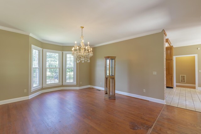 7902 Ooltewah Georgetown Rd, Ooltewah, TN 37363 - empty room featuring a chandelier, light wood-style floors, baseboards, and crown molding