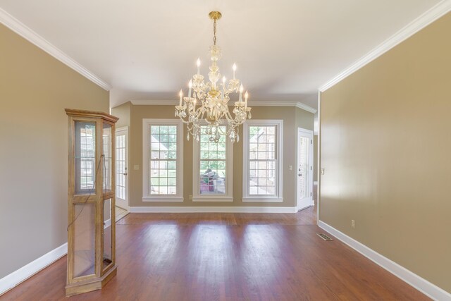 7902 Ooltewah Georgetown Rd, Ooltewah, TN 37363 - unfurnished dining area with baseboards, ornamental molding, wood finished floors, and a chandelier