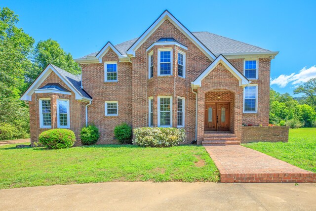 7902 Ooltewah Georgetown Rd, Ooltewah, TN 37363 - traditional-style house with a front yard, brick siding, and roof with shingles