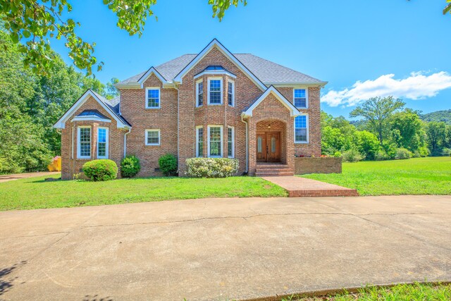 7902 Ooltewah Georgetown Rd, Ooltewah, TN 37363 - view of front of home with brick siding and a front lawn