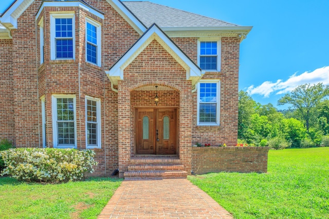 7902 Ooltewah Georgetown Rd, Ooltewah, TN 37363 - traditional-style house featuring brick siding, a front yard, roof with shingles, and french doors