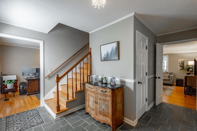 821 Ravine Rd, Signal Mountain, TN 37377 - staircase with crown molding, a textured ceiling, baseboards, and a chandelier