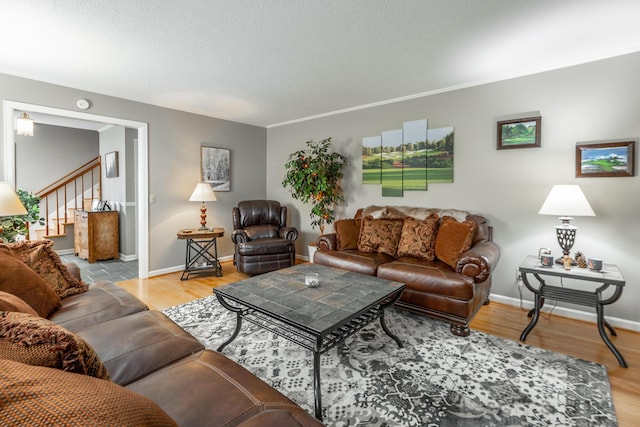 821 Ravine Rd, Signal Mountain, TN 37377 - living room featuring wood finished floors, stairway, baseboards, and a textured ceiling