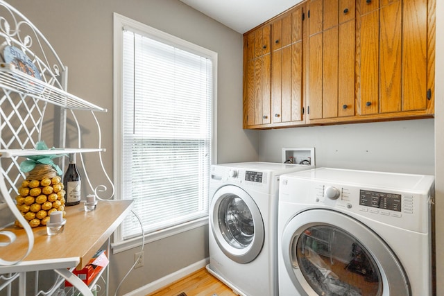 821 Ravine Rd, Signal Mountain, TN 37377 - laundry room with cabinet space, washing machine and dryer, baseboards, and light wood-type flooring