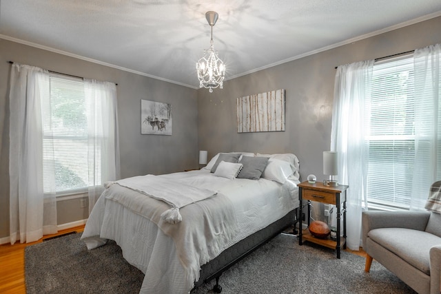821 Ravine Rd, Signal Mountain, TN 37377 - bedroom featuring a chandelier, wood finished floors, crown molding, and baseboards