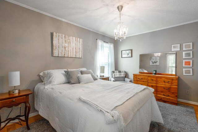 821 Ravine Rd, Signal Mountain, TN 37377 - bedroom with a chandelier, wood finished floors, ornamental molding, and baseboards